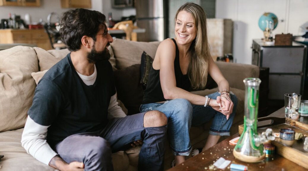 a couple looking at each other after smoking weed