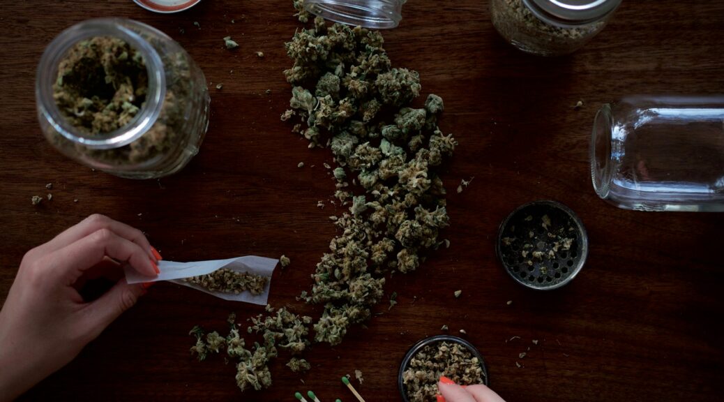 a woman rolling a joint from her stash